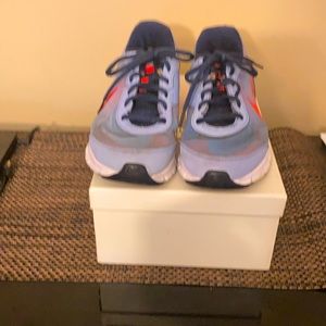 Nike powder blue/deep orange running shoes.